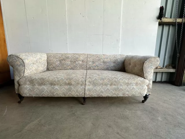 A large Victorian button back sofa