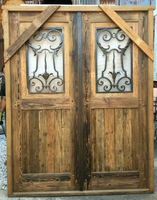 Double wooden Spanish door with hand forged wrought iron insert