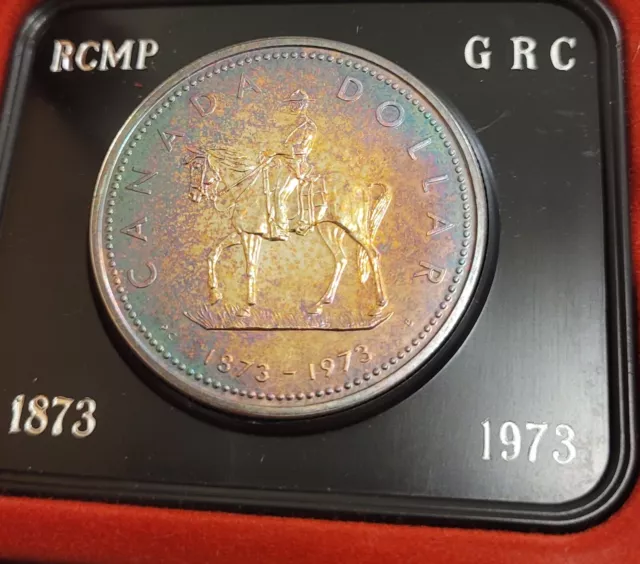 1973 Canada Silver Dollar UNCIRCULATED Remarkable rainbow toning RCMP Mountie.