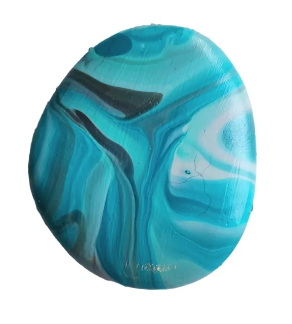 acrylic paint pouring paperweight in beautiful shades of aqua, on river rock