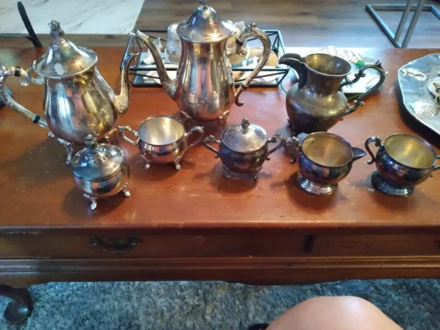 set of seven silver plated items. two tea pots and some small creamer pieces