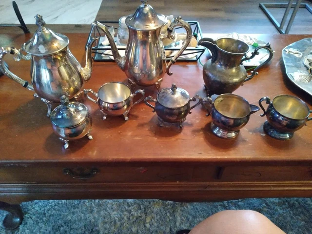 set of seven silver plated items. two tea pots and some small creamer pieces