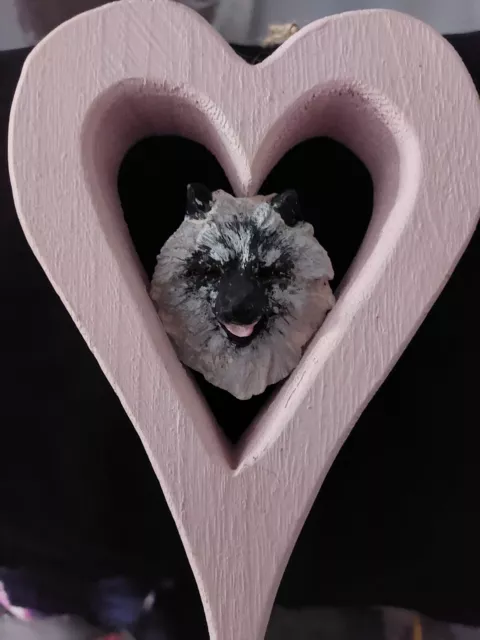 keeshond head in a wooden heart