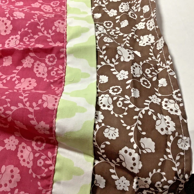 The PEANUTSHELL Dust Ruffle Crib Skirt layered in Pink Brown and Green Floral
