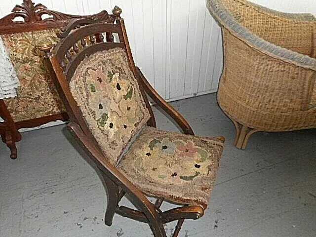 Antique folding chair with carpet upholstery