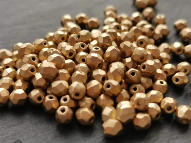 Czech fire polished small glass beads dark metal gold 4 mm pack of 100