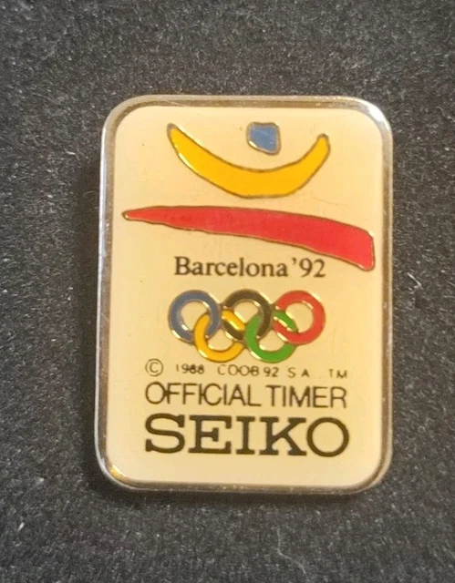 pin's JO Barcelone 1992 - partenariat montre Seiko (doré) hauteur: 1,6 cm