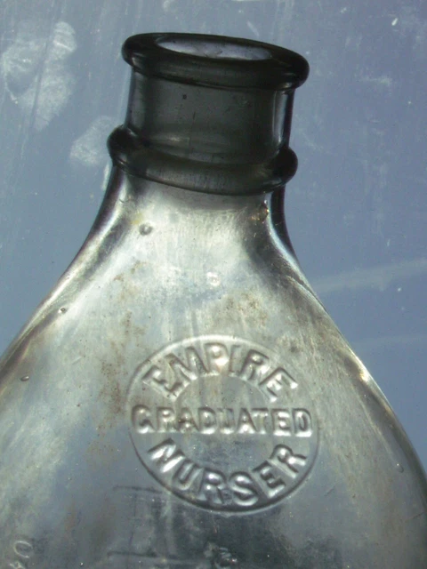 Rare curved, angled 8 oz. glass Empire Graduated Nurser marked baby milk bottle