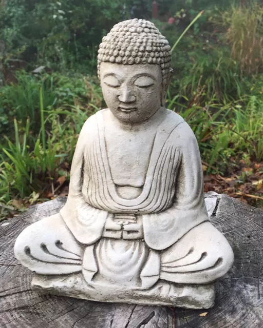 Little Buddha statue stone home or garden ornament aged white or bronze