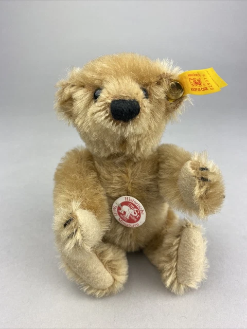 A STEIFF MINIATURE TEDDY BABY, (7309), jointed, blonde mohair, brown and black g