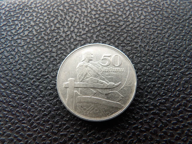 Latvia 1922 50 santimu coin standing figure holding tiller of boat sail on right