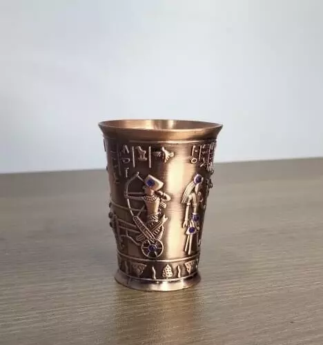 Ancient Egyptian antiques - A coffee cup with ancient hieroglyphs made of metal