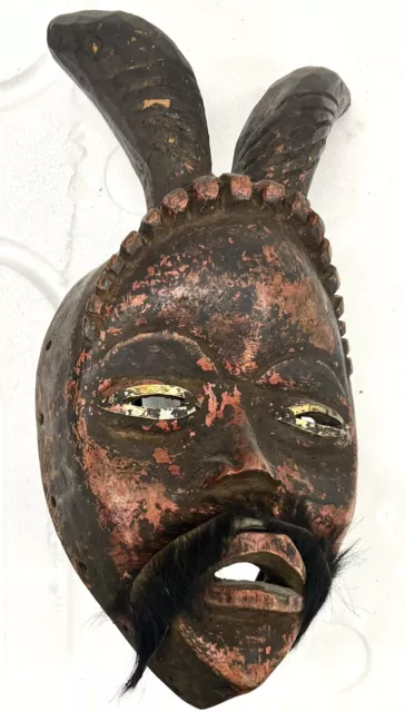 Baule, Ivory Coast: an old mask with two tall horns and mustache