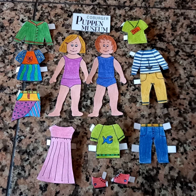 FROM COBURG DOLL MUSEUM: NOSTALG. CUTTING DOLLS WITH CLOTHES PLAYED pl