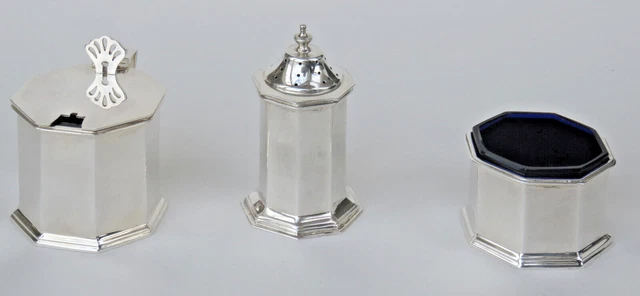 An antique George VI (1937) sterling silver three-piece condiment set + 2 spoons
