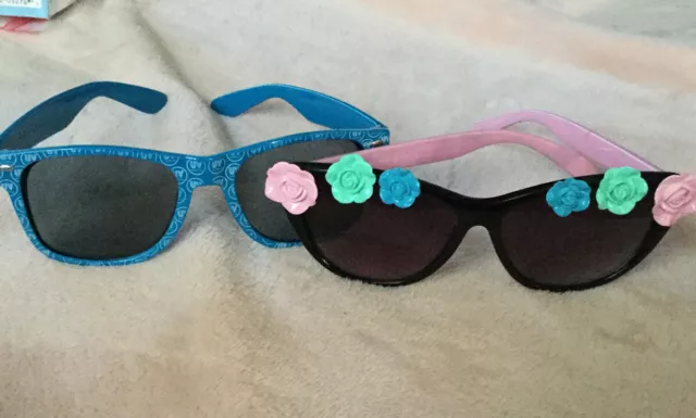 Lot Of 2 Specialty Sunglasses Blue Be UV Vodka & Pink/Black With Roses