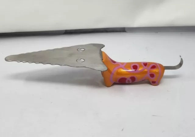 Servidor de pasteles Pylones Filou Francia perro salchicha naranja púrpura magenta
