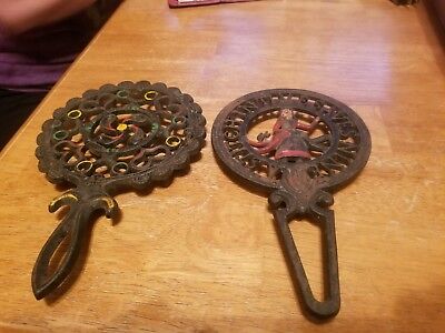 Lot of 2 Vintage Cast Iron Trivets 1tulip 1 A Stitch in Time saves nine 2-wilton
