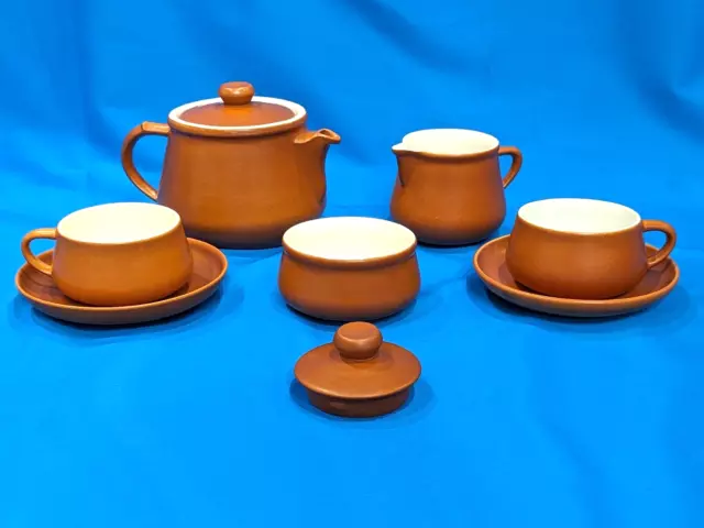 Honiton Pottery Pieces: Teapot, two teacups, saucers, milk jug, sugar bowl