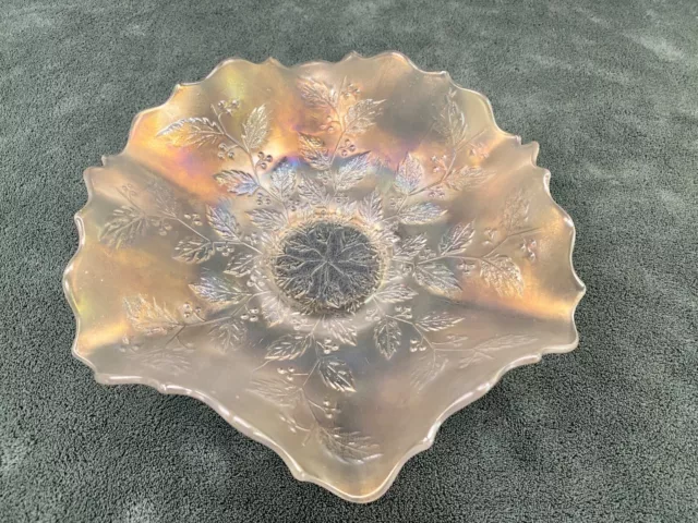 iridescent carnival glass bowl with ruffled edges.
