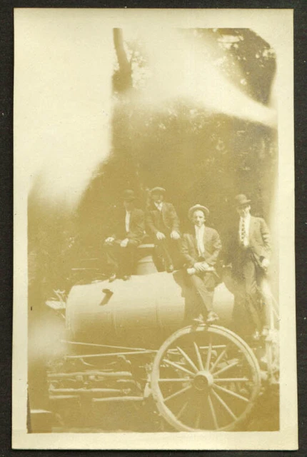 Four men seated on live steam tractor photo 1910s
