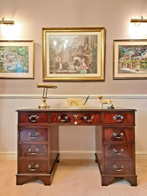 A beautifully finished antique Georgian style, Flame Mahogany twin pedestal desk