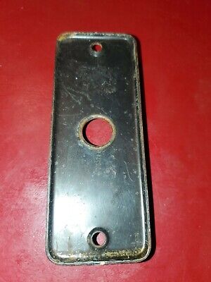 Vintage small metal door back  plate. 4" by 1/2"  Holes center to center 3 1/4". 2