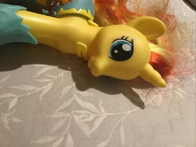 my little pony yellow horse with yellow and orange streaked hair and wearing sho 2