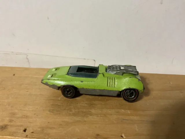 Hot Wheel Redline Peeping Bomb from 1969 color is green played with.