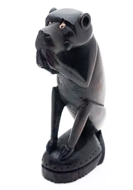 An unusual African Carved ebony seated female baboon figurine holding its mouth.