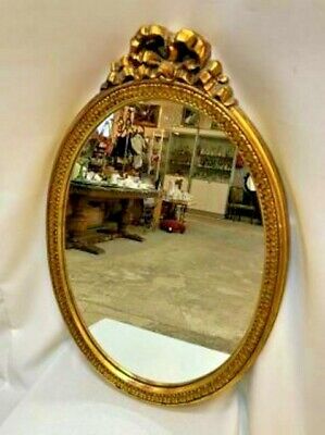 a vintage , antique style , golden wall mirror