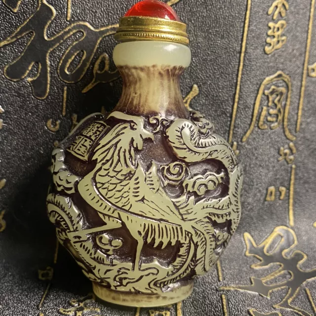 Ancient Chinese beautifully carved dragon and phoenix luminous snuff bottle