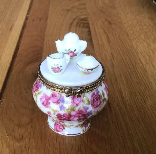 Vintage porcelain trinket box shaped as pot with tea set on the lid pink flowers