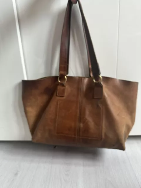 hand made In Africa leather tote By made Brand with hammered brass ring handle