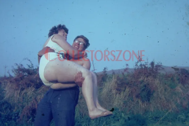 35mm Slide 1970's man lifting a voluptuous woman Humour Glamour