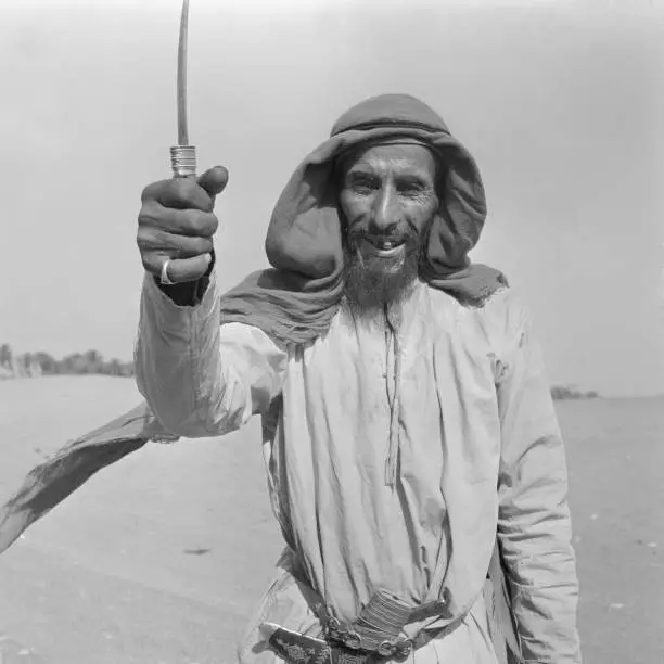 Camel herder seen here showing off dagger Abu Dhabi July 1965 Old Photo 1