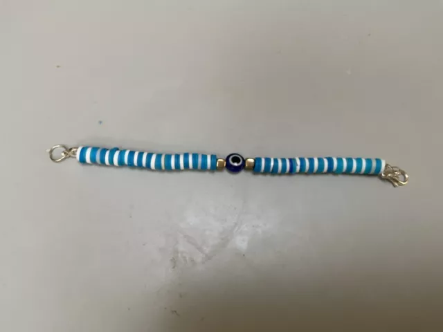 Blue/white clay bead bracelet with silver beads in middle with an evil eye bead
