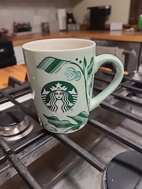 Starbucks coffee/tea 10 oz. mug/cup. Mint green with leaves with ivory interior.