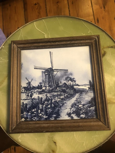 Antique Delft blue and white framed tile depicting interesting scenes