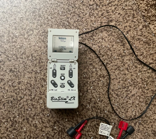 Bio Stim Tens LX with two packages of unused electrodes. 