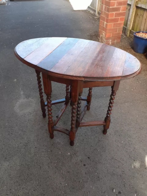 small old oak oval drop leaf table with barley twist legs good condition for age