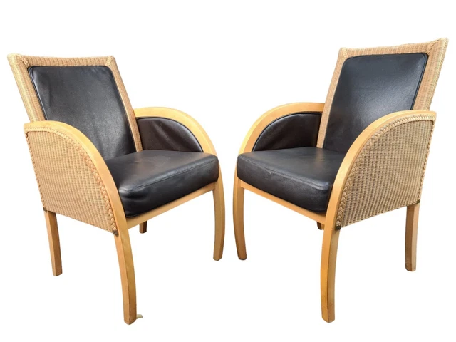 2 Rattan and black leather armchairs Lloyd Loom armchair