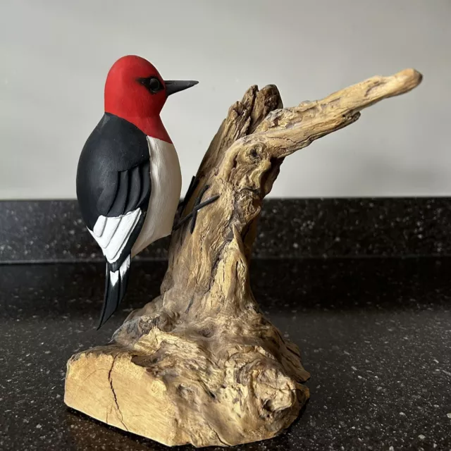 carved wood bird on driftwood