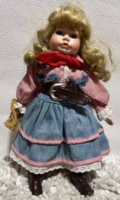The Leonardo Collection Porcelain Doll Cowgirl LP4454. Her name is Dolly 15”