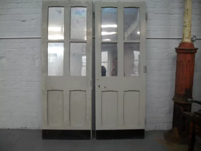 pair of big heavy paneled doors mill school double doors mirror front blank back