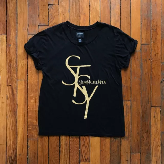 Stussy World Wide Women Black Shiny Gold Print Spell Out Graphic T Shirt Top