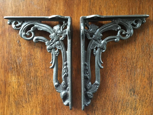 A pair of cast iron Victorian style foliage shelf brackets shelving cistern