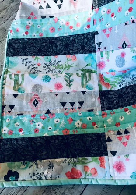100% cotton baby quilt, measuring a cozy 38x27 inches, designed with utmost care