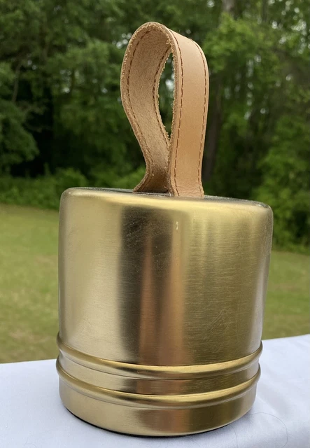 Weighted brass door stop with leather strap