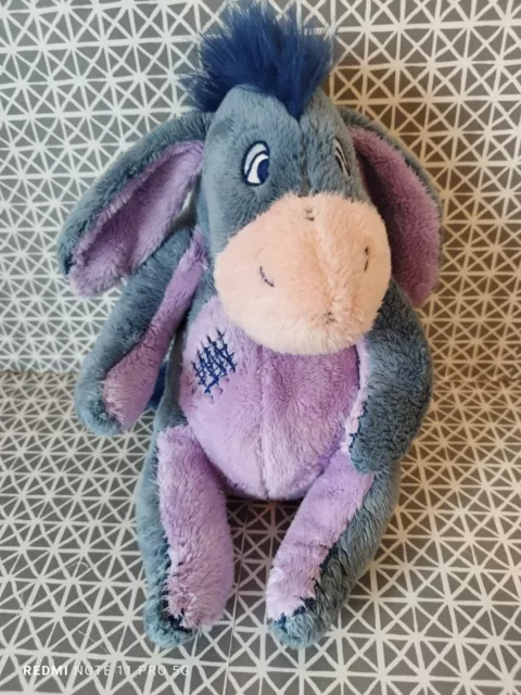 Peluche doudou Bourriquet bleu mauve rapiécé 25 cm Disney Nicotoy